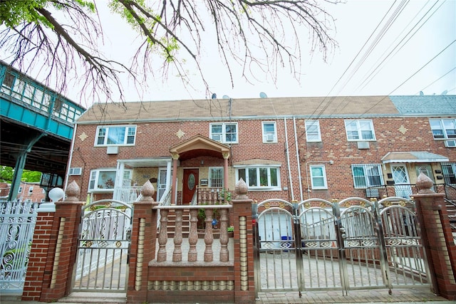 10124 78th St, Ozone Park, NY 11416 - view of property with a gate, brick siding, and a fenced front yard