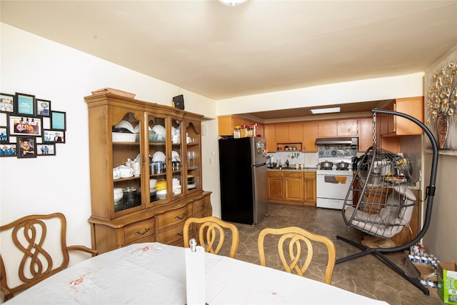 10124 78th St, Ozone Park, NY 11416 - kitchen featuring freestanding refrigerator, white stove, under cabinet range hood, and a sink