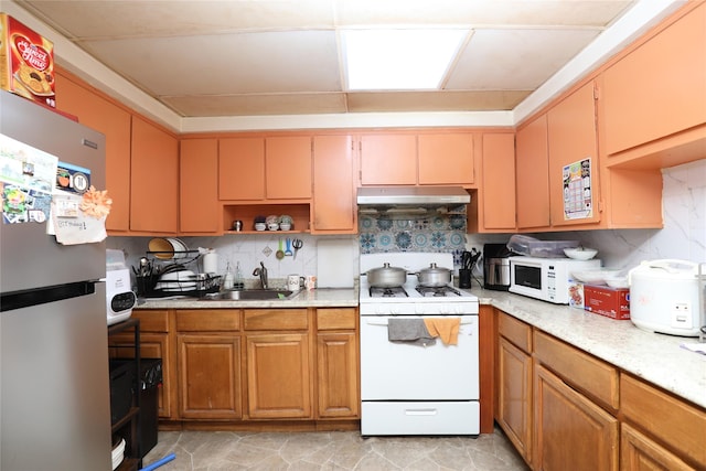 10124 78th St, Ozone Park, NY 11416 - kitchen featuring white appliances, a sink, under cabinet range hood, open shelves, and decorative backsplash