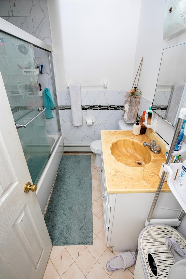 10124 78th St, Ozone Park, NY 11416 - full bath featuring tile patterned flooring, vanity, bath / shower combo with glass door, tile walls, and toilet