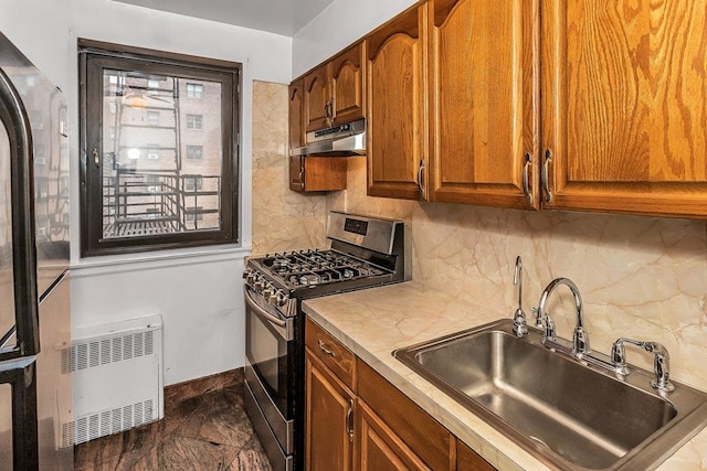 87-40 Francis Lewis Blvd Unit B38, Queens Village, NY 11427 - kitchen featuring stainless steel gas range, a sink, under cabinet range hood, backsplash, and heating unit