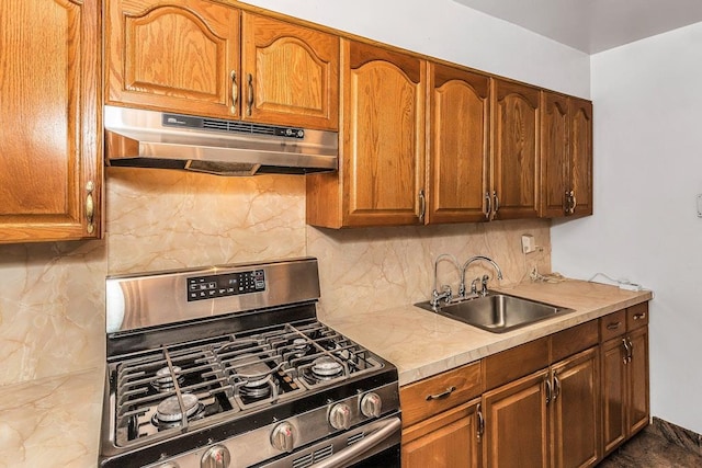 87-40 Francis Lewis Blvd Unit B38, Queens Village, NY 11427 - kitchen with stainless steel gas range oven, under cabinet range hood, a sink, light countertops, and tasteful backsplash