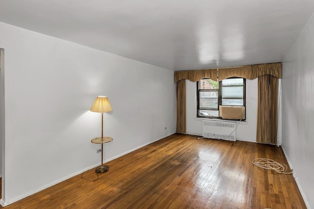 87-40 Francis Lewis Blvd Unit B38, Queens Village, NY 11427 - unfurnished room with radiator heating unit, hardwood / wood-style flooring, and baseboards