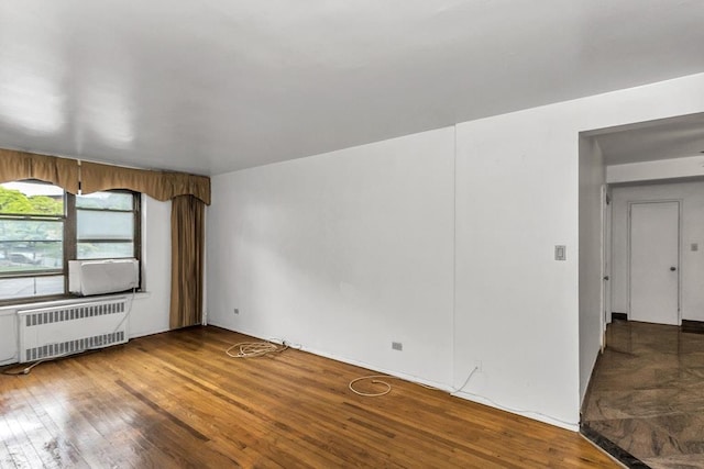 87-40 Francis Lewis Blvd Unit B38, Queens Village, NY 11427 - empty room with radiator heating unit and wood finished floors