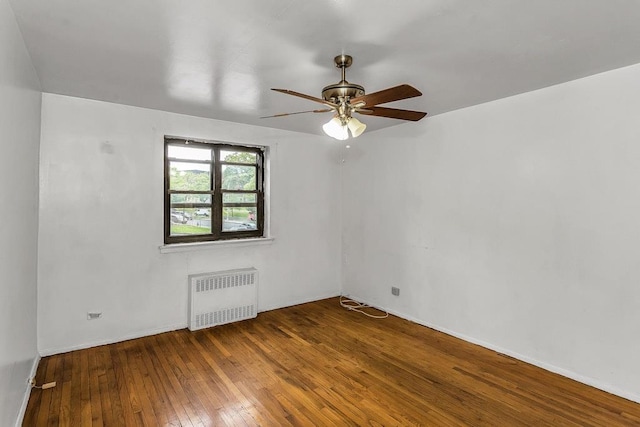87-40 Francis Lewis Blvd Unit B38, Queens Village, NY 11427 - spare room with radiator heating unit, hardwood / wood-style flooring, a ceiling fan, and baseboards