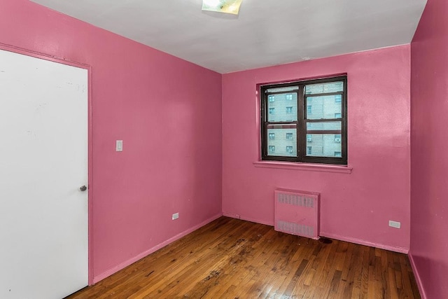 87-40 Francis Lewis Blvd Unit B38, Queens Village, NY 11427 - unfurnished room with radiator, wood-type flooring, and baseboards