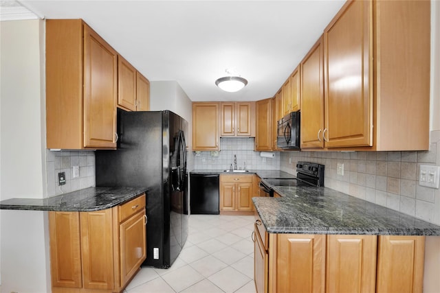 kitchen featuring black appliances, a sink, light tile patterned floors, decorative backsplash, and a peninsula
