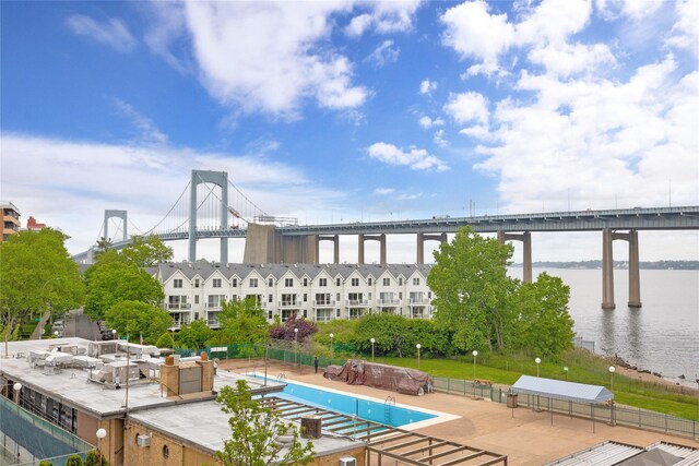 view of pool featuring a water view