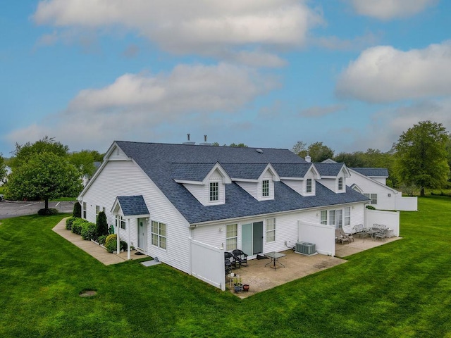 43 Summerfield Ln N Unit 43, Aquebogue, NY 11901 - rear view of house with a patio, a lawn, central AC unit, and a shingled roof