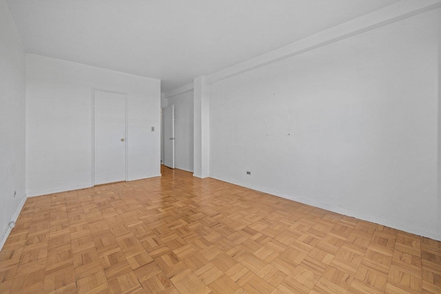 spare room with baseboards
