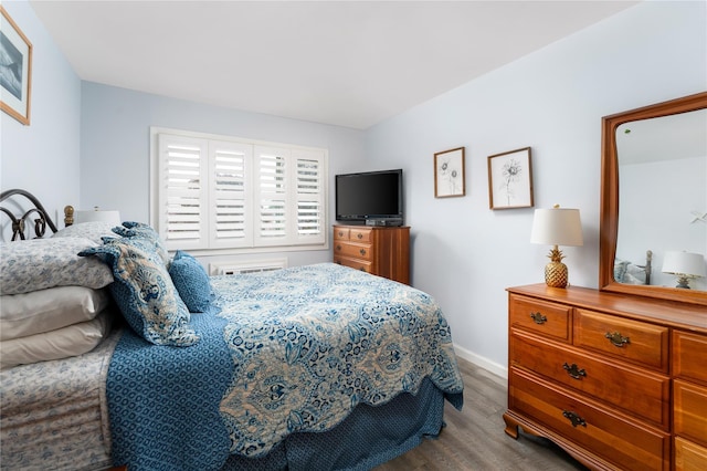 bedroom with wood finished floors and baseboards