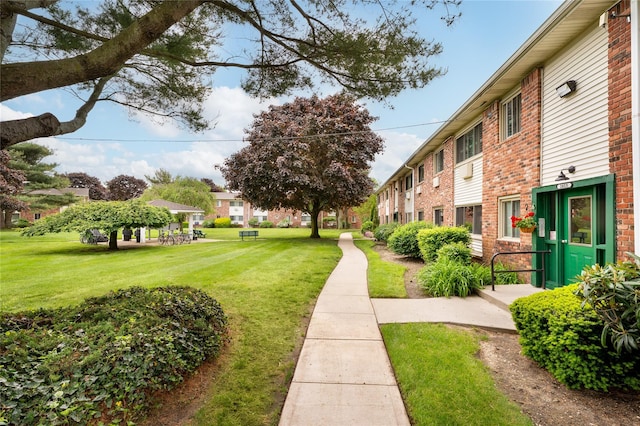 surrounding community featuring a lawn and a residential view