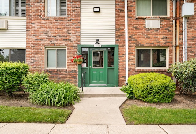 property entrance featuring brick siding