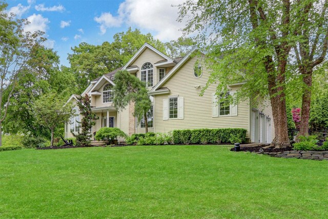 12 Mill River Rd, Setauket, NY 11733 - view of front facade featuring a front yard and a garage