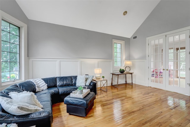 12 Mill River Rd, Setauket, NY 11733 - living room featuring french doors, plenty of natural light, wainscoting, wood finished floors, and a decorative wall