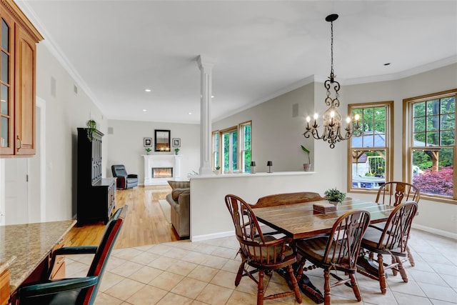 12 Mill River Rd, Setauket, NY 11733 - dining space featuring plenty of natural light, light tile patterned flooring, a lit fireplace, crown molding, and recessed lighting
