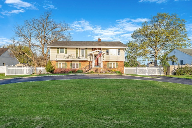 146 Awixa Ave, Bay Shore, NY 11706 - raised ranch with a gate, brick siding, driveway, and a chimney