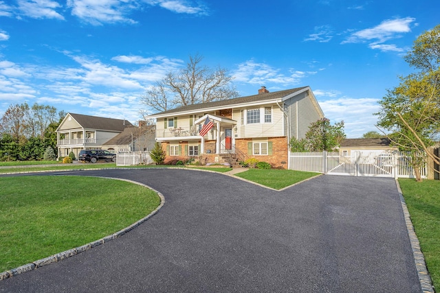 146 Awixa Ave, Bay Shore, NY 11706 - bi-level home with a gate, brick siding, driveway, and a chimney