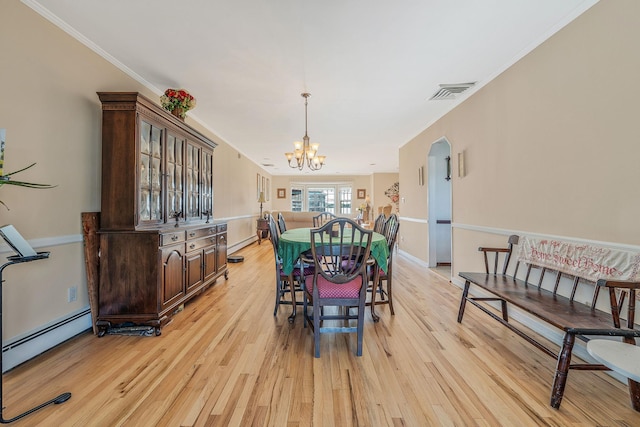 146 Awixa Ave, Bay Shore, NY 11706 - dining room with a chandelier, light wood finished floors, baseboard heating, and ornamental molding