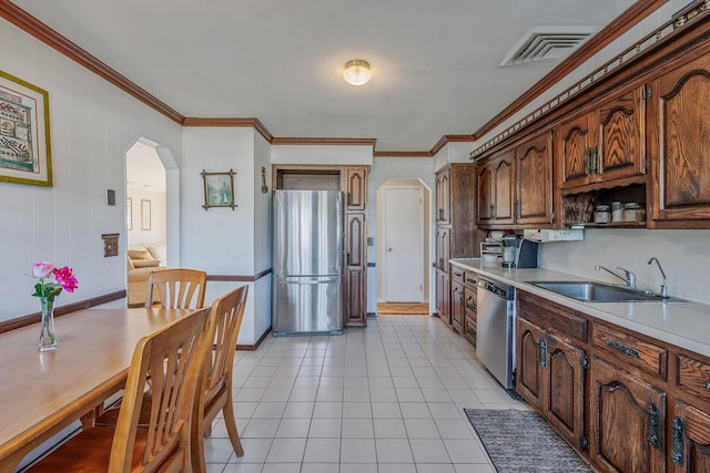 146 Awixa Ave, Bay Shore, NY 11706 - kitchen featuring stainless steel appliances, arched walkways, a sink, light countertops, and ornamental molding