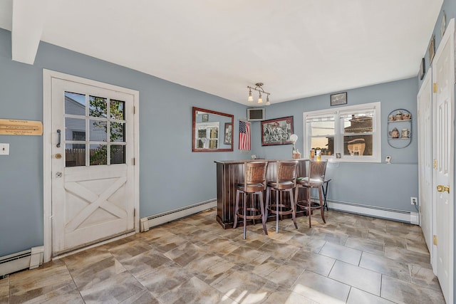 146 Awixa Ave, Bay Shore, NY 11706 - dining space with a baseboard heating unit, a baseboard radiator, a dry bar, and healthy amount of natural light