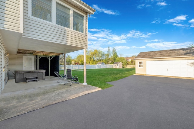 146 Awixa Ave, Bay Shore, NY 11706 - view of yard featuring a hot tub, an outdoor structure, a patio, and a garage