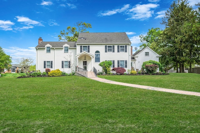 21 Demarre Ln, Bayport, NY 11705 - view of front of house featuring a chimney and a front yard