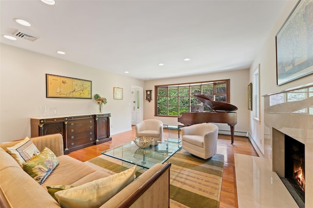 50 Burnside Dr, Hastings-On-Hudson, NY 10706 - living room featuring a baseboard radiator, light wood finished floors, plenty of natural light, recessed lighting, and a fireplace