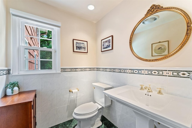 50 Burnside Dr, Hastings-On-Hudson, NY 10706 - half bathroom featuring tile walls and a wainscoted wall