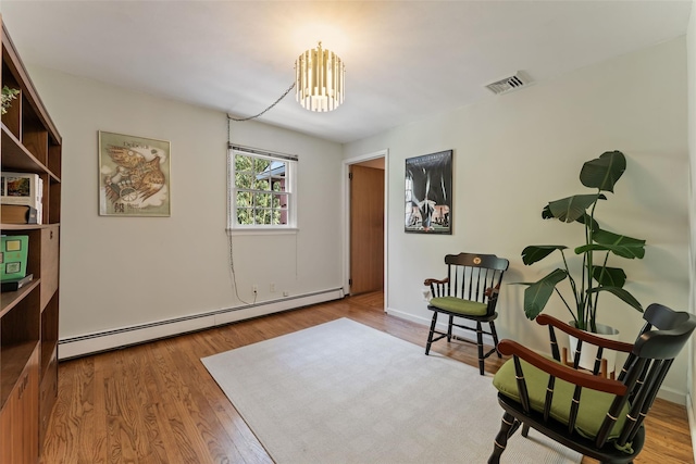 50 Burnside Dr, Hastings-On-Hudson, NY 10706 - living area with baseboard heating, wood finished floors, and a chandelier