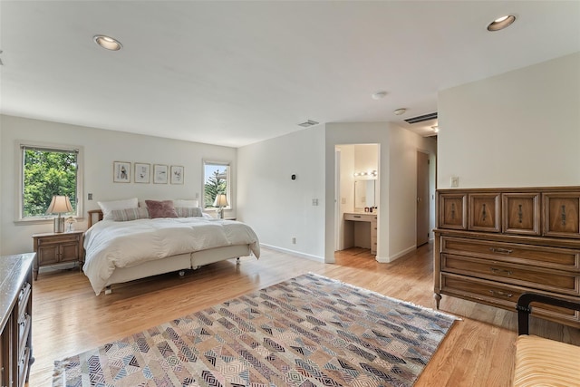 50 Burnside Dr, Hastings-On-Hudson, NY 10706 - bedroom featuring multiple windows, light wood-type flooring, recessed lighting, and ensuite bathroom