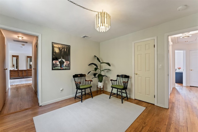 50 Burnside Dr, Hastings-On-Hudson, NY 10706 - sitting room with attic access, wood finished floors, and a chandelier