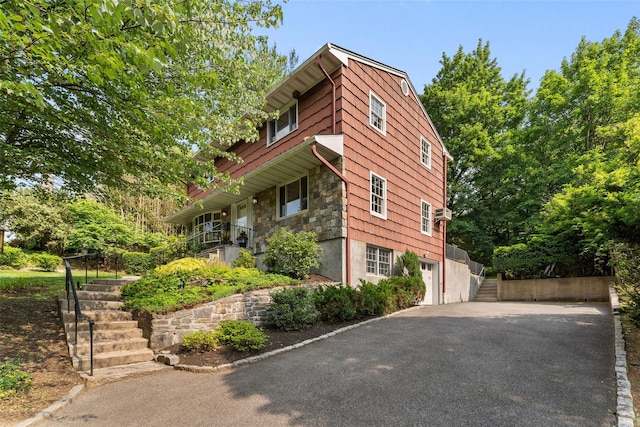 50 Burnside Dr, Hastings-On-Hudson, NY 10706 - view of side of property featuring stairs, driveway, a garage, and stone siding