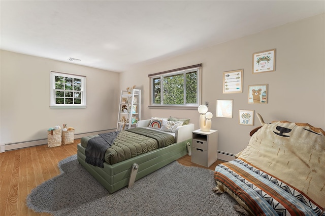 50 Burnside Dr, Hastings-On-Hudson, NY 10706 - bedroom with baseboard heating, multiple windows, and wood finished floors