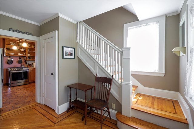 staircase with ornamental molding and baseboards