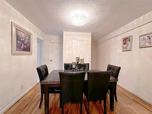 270 N Broadway Unit 2Hi, Yonkers, NY 10701 - dining room with a chandelier, light wood-style flooring, and baseboards
