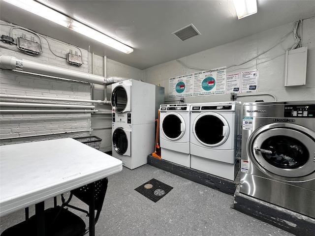 270 N Broadway Unit 2Hi, Yonkers, NY 10701 - communal laundry room with stacked washer / drying machine, concrete block wall, and washing machine and dryer