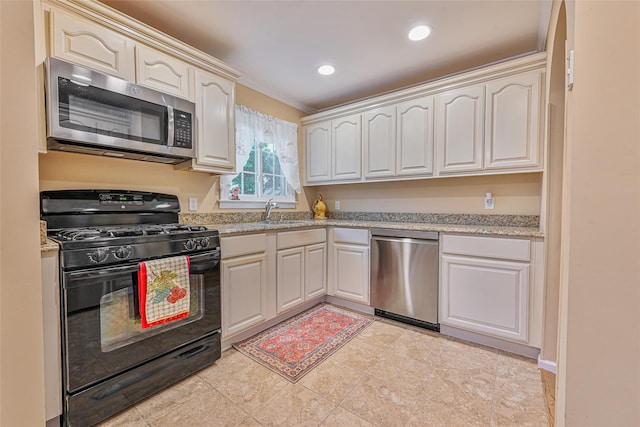 1652 Baker Ave, Merrick, NY 11566 - kitchen featuring appliances with stainless steel finishes, a sink, crown molding, recessed lighting, and light stone counters