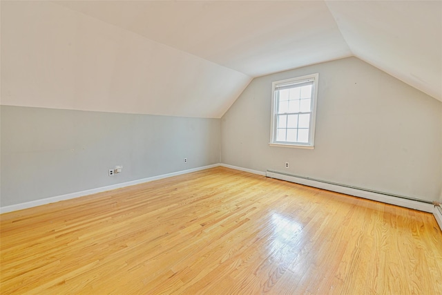 1652 Baker Ave, Merrick, NY 11566 - bonus room with lofted ceiling, wood finished floors, baseboards, and a baseboard heating unit