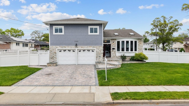 3161 Grand Ave, Baldwin Harbor, NY 11510 - view of front of house with stone siding, an attached garage, and decorative driveway
