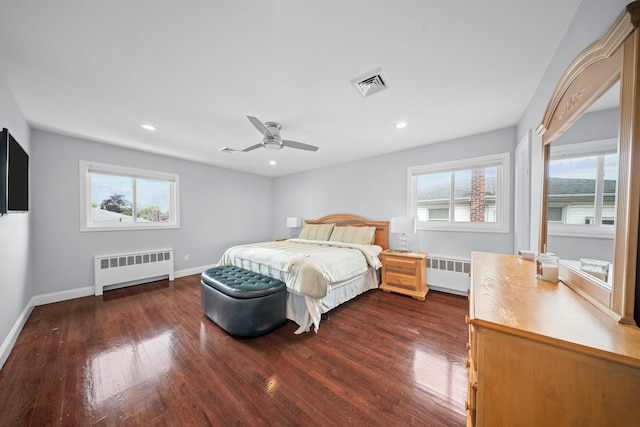 3161 Grand Ave, Baldwin Harbor, NY 11510 - bedroom with radiator, dark wood-type flooring, multiple windows, and recessed lighting