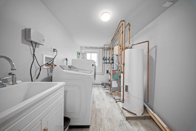 3161 Grand Ave, Baldwin Harbor, NY 11510 - clothes washing area featuring gas water heater, washing machine and clothes dryer, and light wood-style flooring