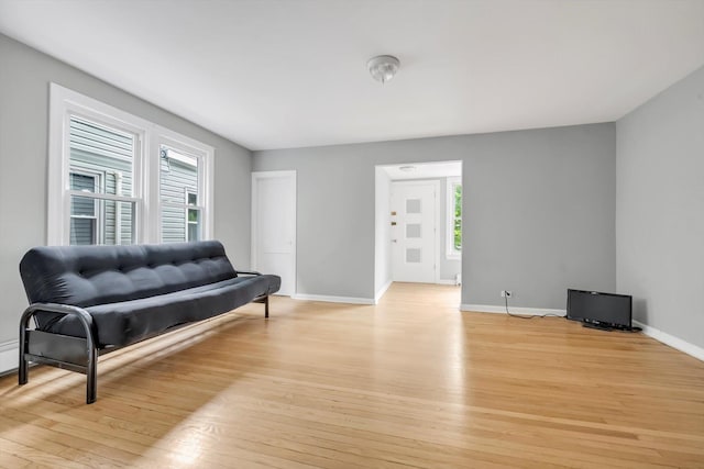 living area with light wood finished floors and baseboards
