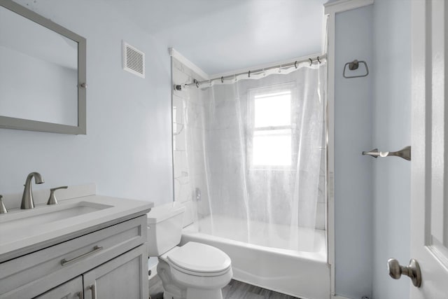bathroom featuring toilet, shower / bath combination with curtain, and vanity