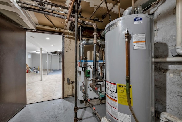utility room featuring water heater and a heating unit