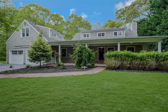 11 The Pkwy, Southampton, NY 11968 - view of front of house featuring a front lawn, a chimney, a porch, and a garage