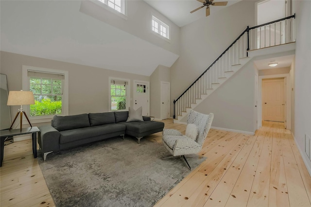 11 The Pkwy, Southampton, NY 11968 - living room featuring hardwood / wood-style flooring, stairway, a high ceiling, and a ceiling fan