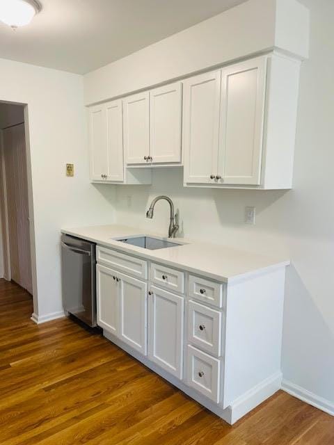 82 Demarest Ave Unit 15, West Nyack, NY 10994 - kitchen featuring a sink, dishwasher, baseboards, white cabinets, and light countertops
