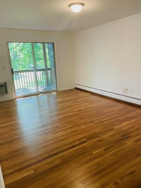 82 Demarest Ave Unit 15, West Nyack, NY 10994 - spare room with wood finished floors, a baseboard heating unit, baseboards, and an AC wall unit