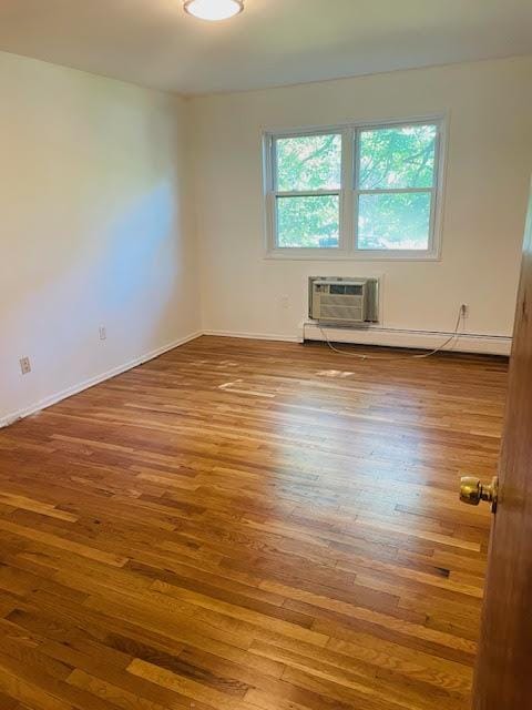 82 Demarest Ave Unit 15, West Nyack, NY 10994 - empty room with hardwood / wood-style floors, a baseboard radiator, a wall mounted air conditioner, and baseboards